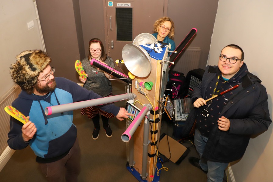 Club goers playing homemade instruments