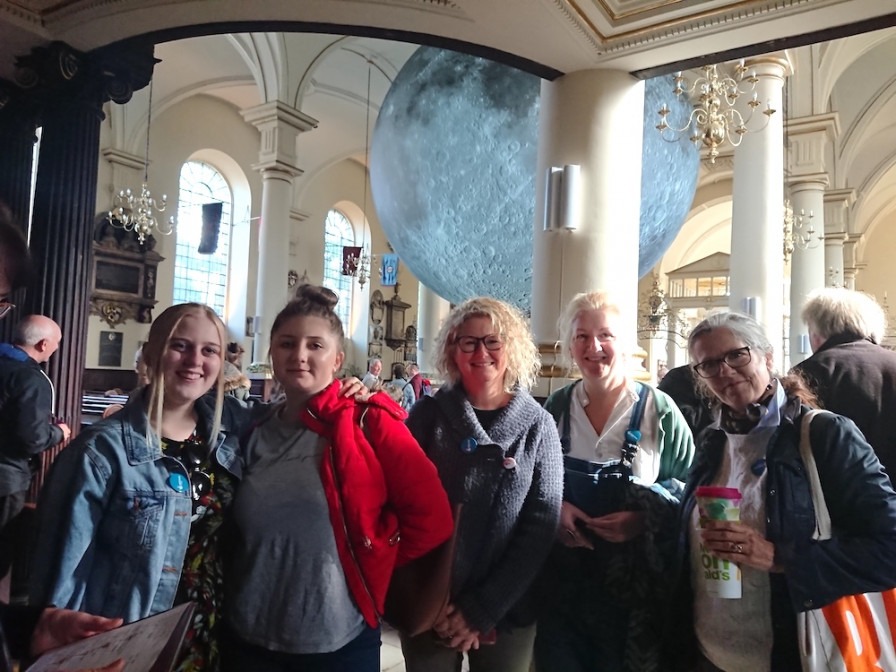 a group of people in front of the Museum of the Moon at Derby Cathedral in Sept 2019