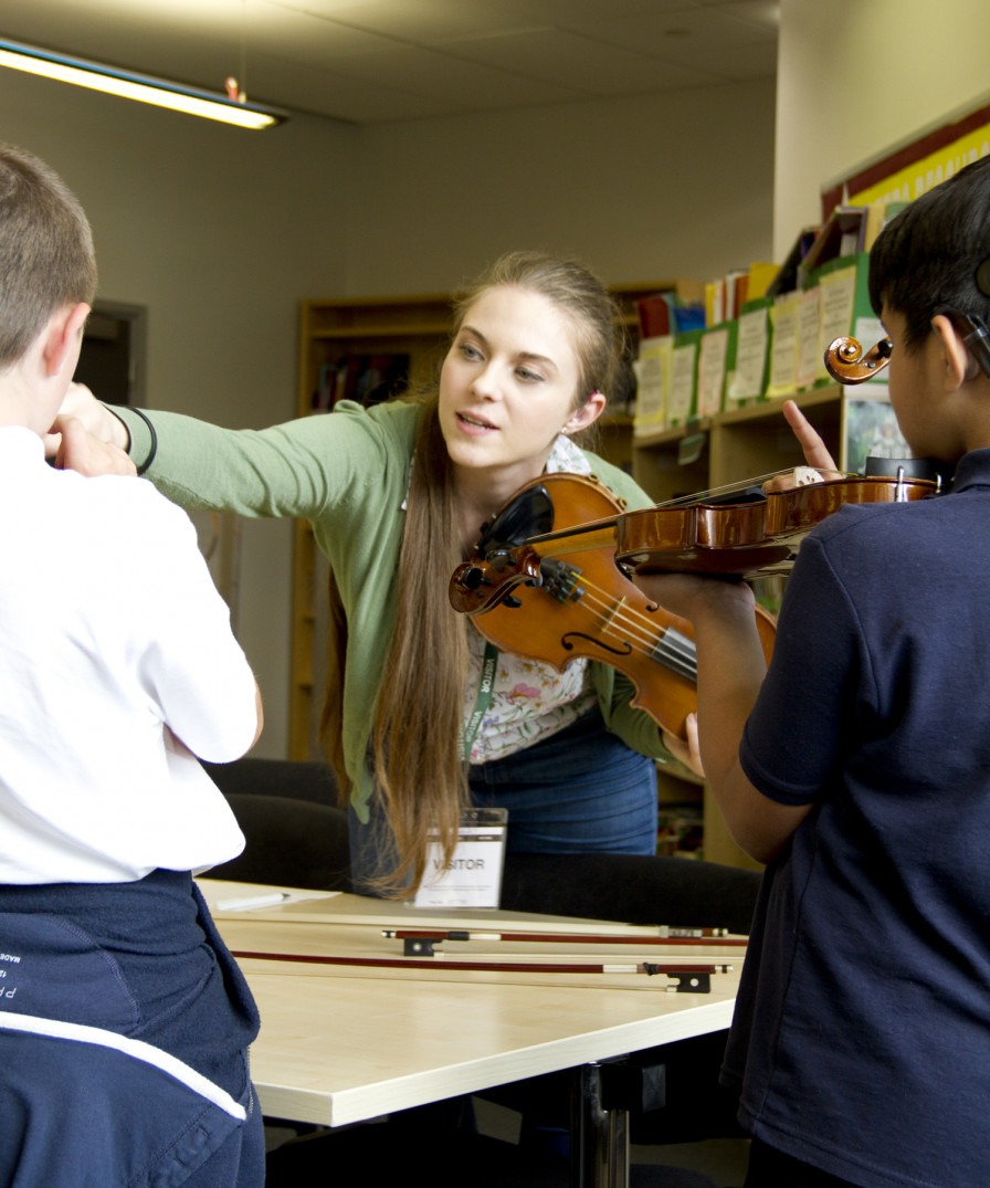 A teacher with two children on Yorkshire Youth and Music's Deaf Young People and Instrumental Learning project