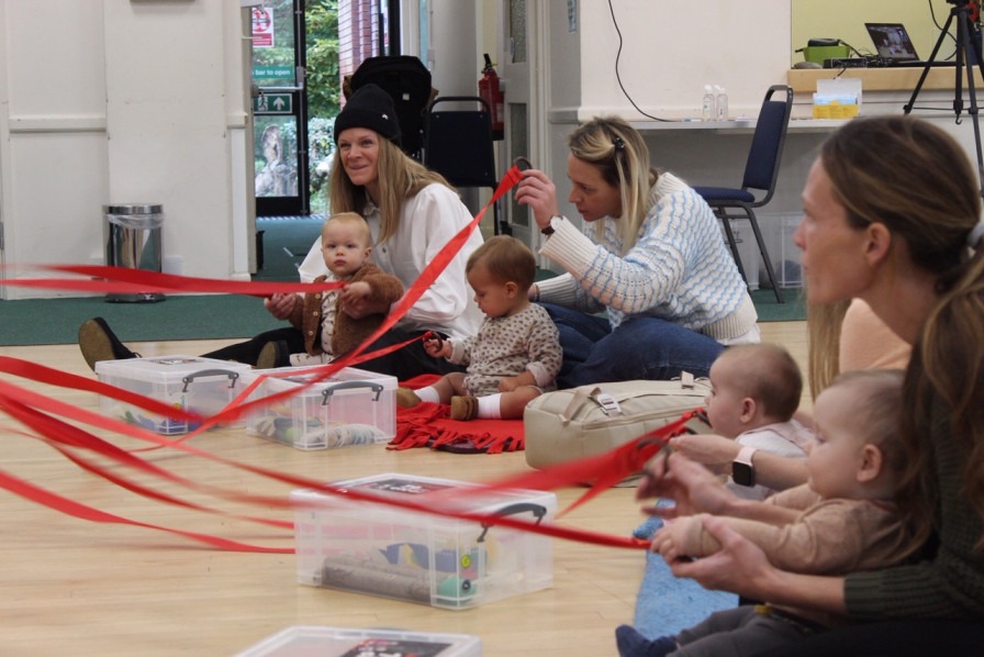 Babies and adults taking part in a music session