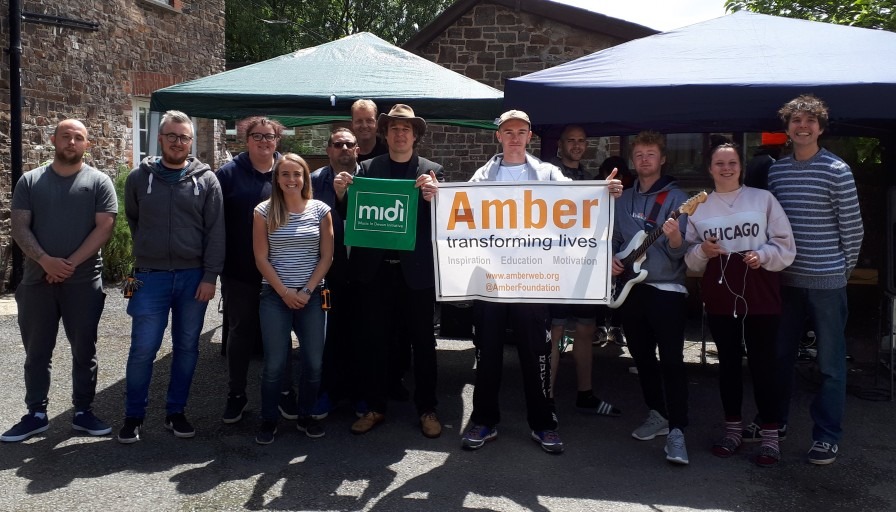 Group of participants at launch event holding up Amber and MIDI banners