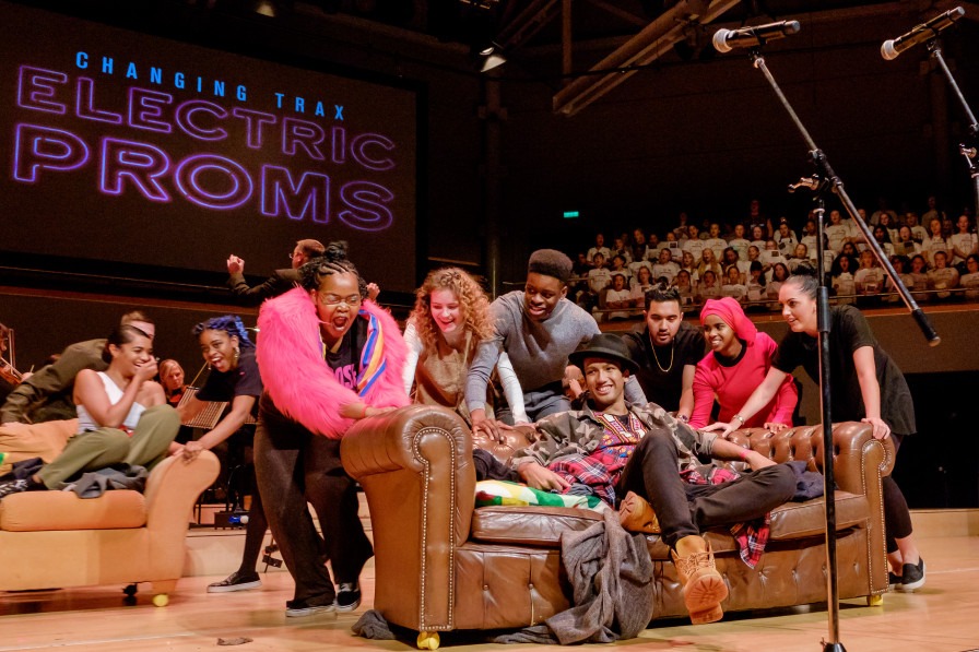 A group of young people smiling and laughing at the Electric Proms