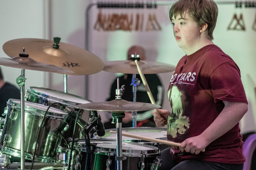 A young person drumming 