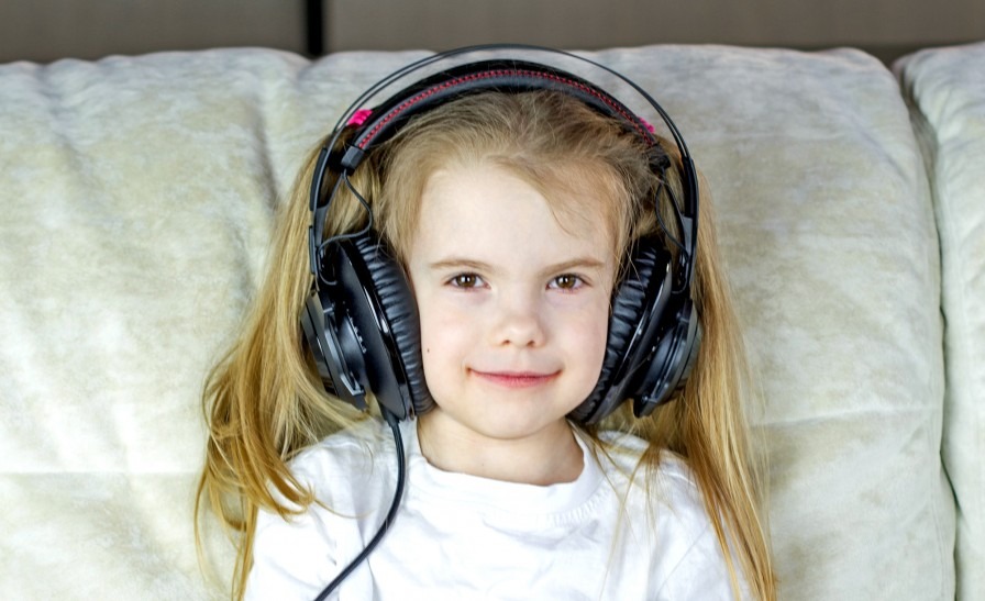 Little girl with big headphones on