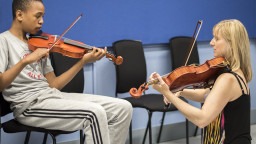 Music Leader with Young Participant, playing violin