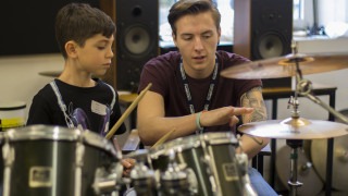 Teacher and Child Playing Drums