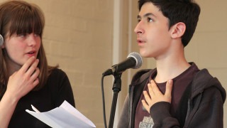 Young person singing into microphone
